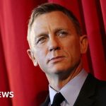 A concert scene from the 2026 Proms featuring a diverse orchestra performing music.