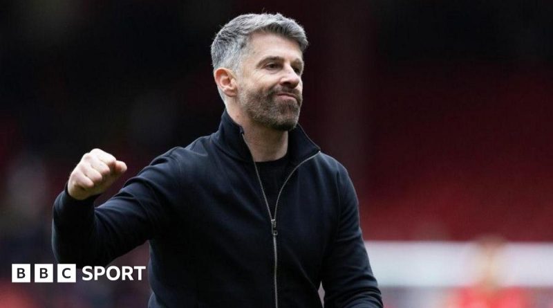 Exciting football match showing action and cheering fans, representing Aberdeen coach Stephen Robinson's impact.