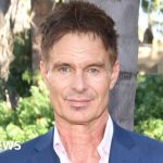 A memorial scene honoring Patrick Muldoon with flowers and candles.