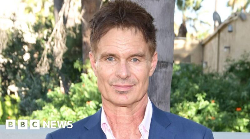 A memorial scene honoring Patrick Muldoon with flowers and candles.