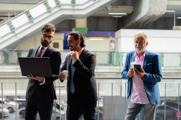 A scene depicting professionals discussing Air India CEO resignation in an airport.