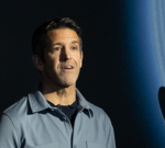 Diverse professionals discussing Apple leadership changes in a modern office setting.