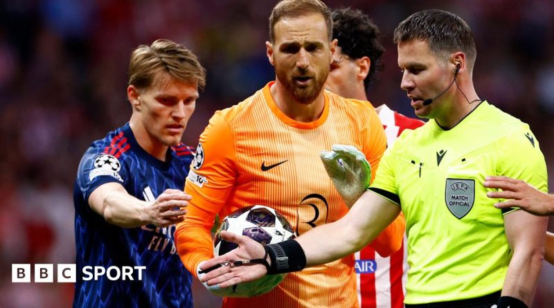 Tense moment during a football match showcasing Arsenal refereeing frustration.