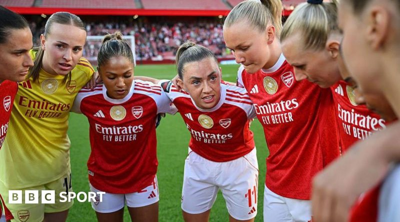 Women soccer players celebrating during a match in the Women's Super League title race.