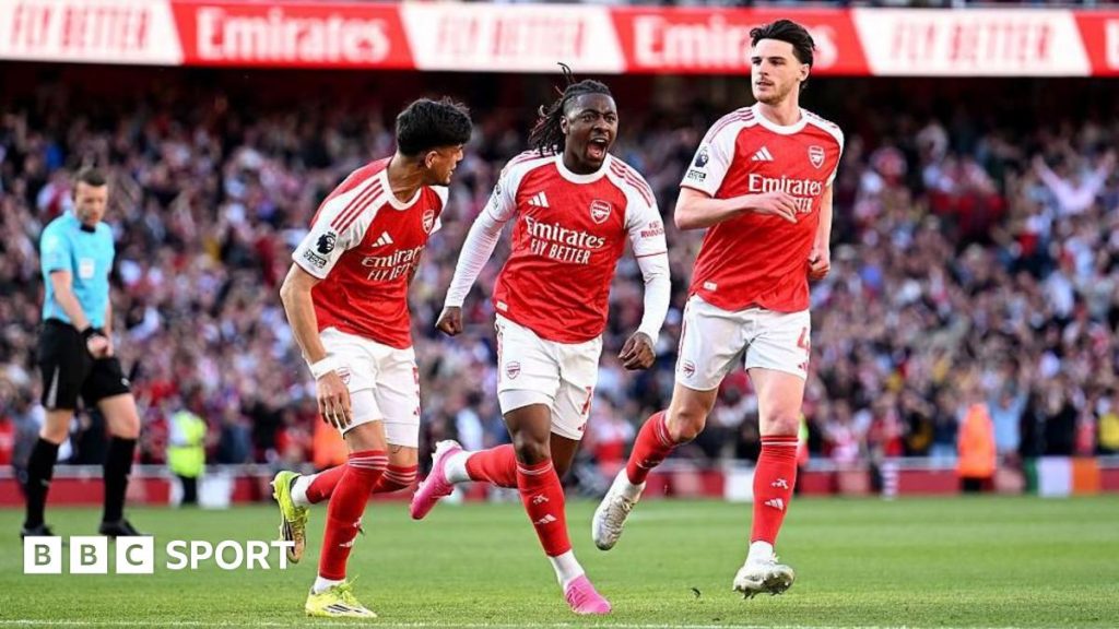 Football players from Arsenal showing determination in a match, highlighting their title hopes.