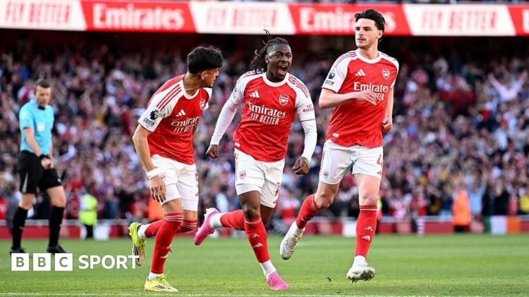 Football players from Arsenal showing determination in a match, highlighting their title hopes.