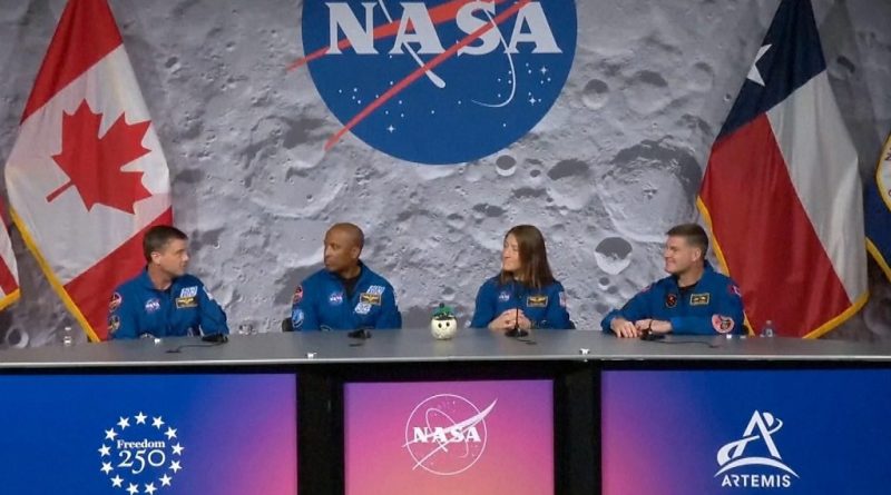 Astronauts in professional attire discussing the Artemis II Moon mission.