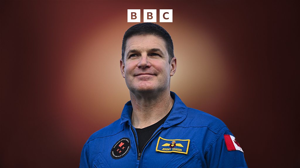 Astronauts discussing the Artemis II mission in a space center.