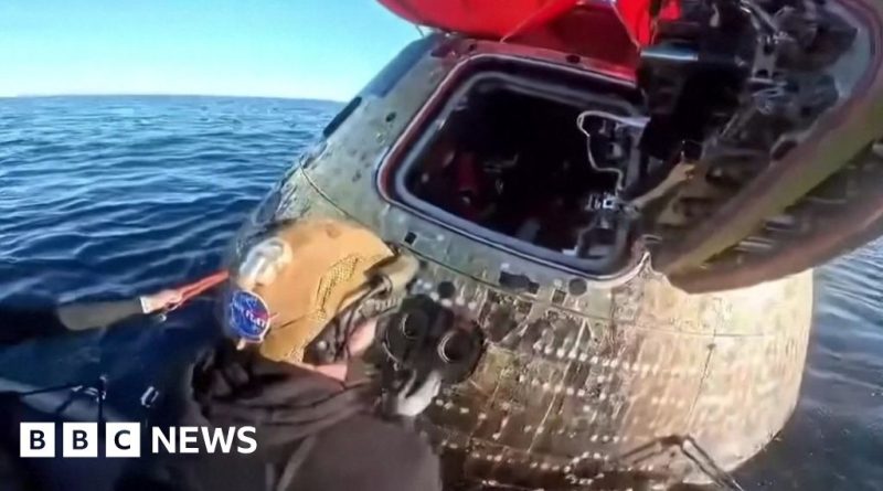 Astronauts joyfully celebrate their reunion after the Orion capsule splashdown.