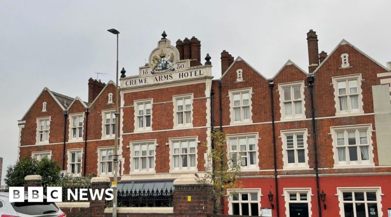 Asylum seekers in professional attire outside military barracks, illustrating the decrease in asylum hotels.