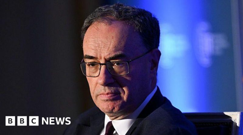 A meeting of economists discussing interest rate decisions in a professional setting.