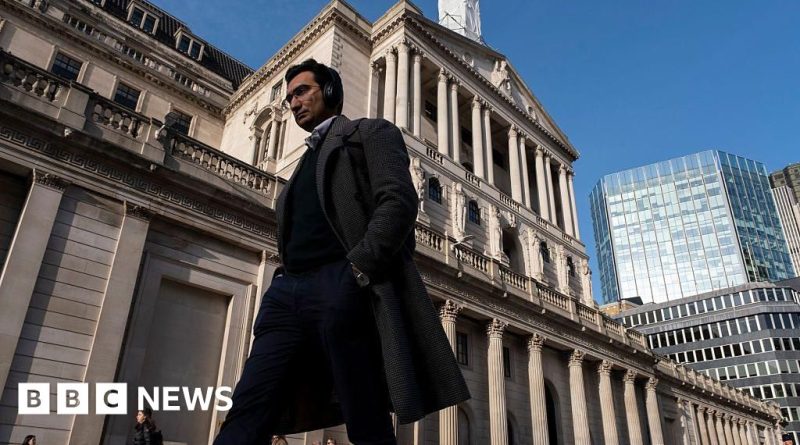 Professionals discussing Bank of England expectations during a meeting.