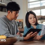 Diverse professionals discussing Bank of England meeting insights related to finances.