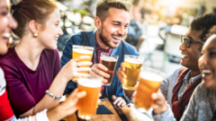 Professionals discussing beer health benefits in a modern office setting.