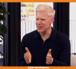 A diverse group of professionals using heart rate trackers while exercising outdoors.