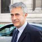 A diverse group discussing billionaire donations in a professional setting.