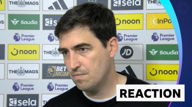 Soccer players in professional attire discussing strategy amidst news of their manager's departure.