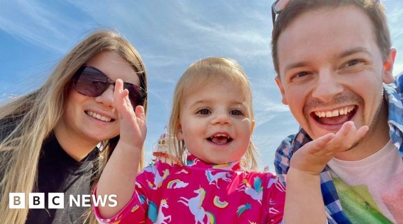 A father and daughter in professional attire reflect on a mother's sacrifice.
