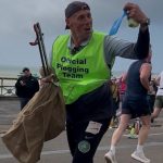 Runners participating in the Brighton Marathon plogging event while collecting litter.