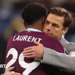 Football players discussing strategies to break the Burnley relegation cycle.