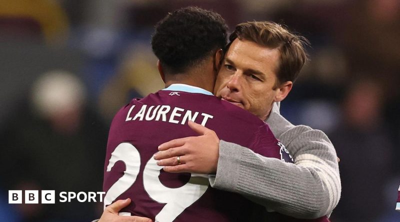 Football players discussing strategies to break the Burnley relegation cycle.