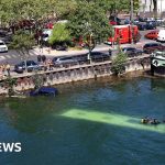 Emergency responders assess a bus accident near the River Seine.