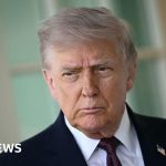 Business professionals discussing Trump tariff refunds in a modern office.