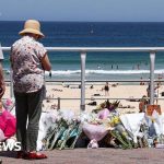 Professionals discussing Bondi shooting gun reform and safety measures in a public space.