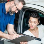 A diverse professional group discussing car finance compensation payments.