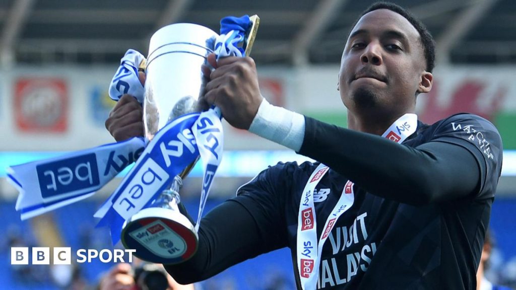 Business executives discussing Nathan Trott transfer in a meeting room.