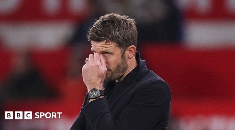 Manchester United challenges as coach strategizes with players in training.