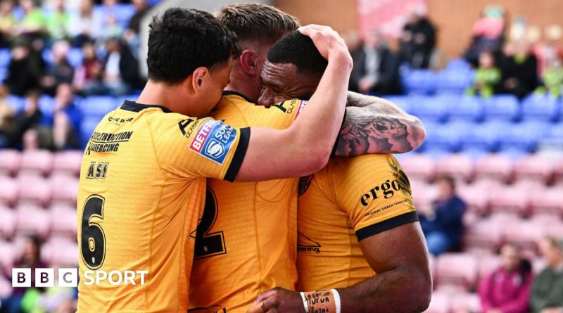 Castleford and Wigan players competing in a Super League rugby match.