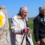 A diverse group walking on King Charles's coastal path in southern England.