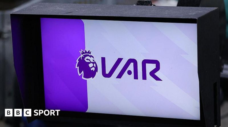 Championship clubs VAR decision discussion among referees on the field.