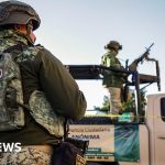 Officials discussing Sinaloa governor drug cartel charges in a meeting.