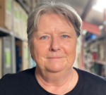 Volunteers loading boxes for charity delivery, highlighting fuel price increase impact on charities.