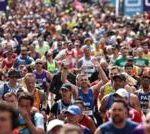 A diverse choir performing at the London Marathon, showcasing community spirit and unity.