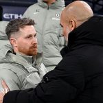 Chelsea interim coach leading football training with team players.