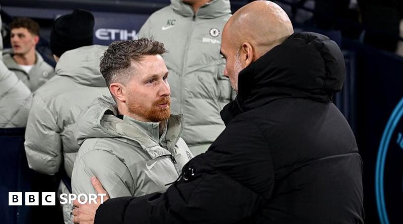 Chelsea interim coach leading football training with team players.