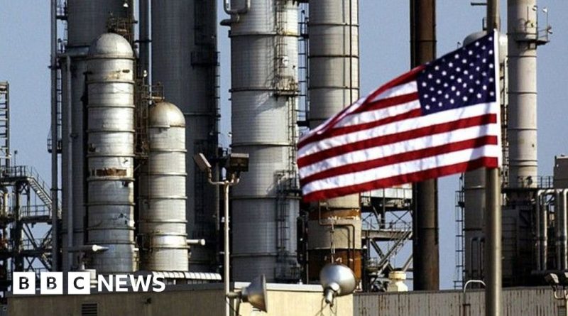 Workers at an oil refinery processing Venezuelan oil in professional attire.