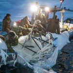 Professionals discussing Chinese spy balloon surveillance measures in an office.