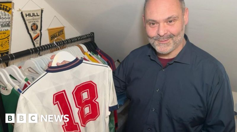 Professionals discussing the value of England football shirts at a market