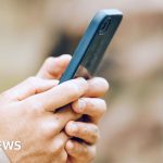 Professionals analyzing a conflict report about Colombian mercenaries in Sudan.