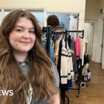 Families at a community pop-up shop selecting free essentials.