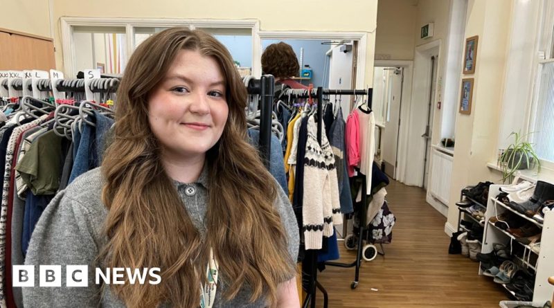 Families at a community pop-up shop selecting free essentials.