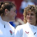 A diverse football team training together, highlighting England's performance concerns.