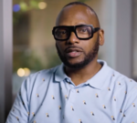 Professionals discussing workplace culture issues at Pride in London.