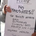 Citizens protesting council weedkiller concerns outside a government building