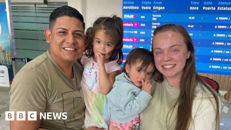Couple discussing deportation challenges in their living room.