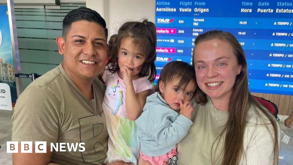 Couple discussing deportation challenges in their living room.